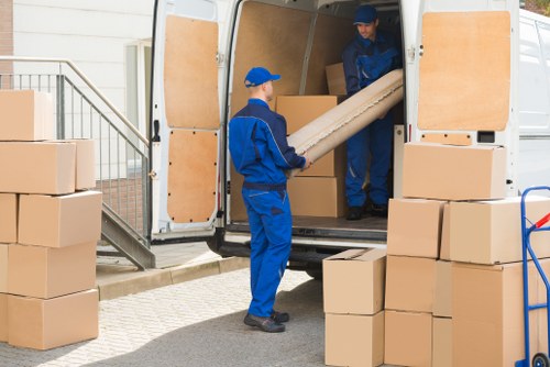 Professional movers handling furniture in a Balham flat move